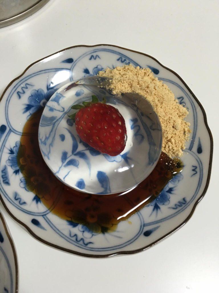 Mizu Shingen mochi japanese refreshing fruity snack. Strawberry inside jelly with peanut powder and brown sugar syrup with fresh strawberry fruit inside.