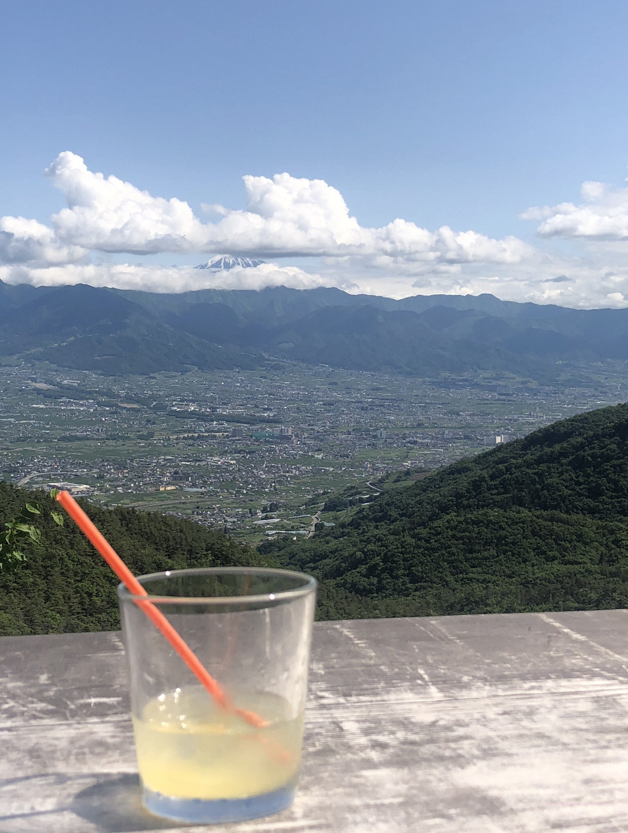 Overlooking view. A town in Yamanashi surrounded with mountais and view of Mt. Fuji.